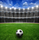 Fototapeta Sport - Soccer ball on green stadium