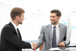 © ASDF - Happy business partners shaking hands in an office