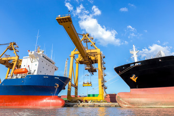 Container cargo freight ship with working crane loading bridge 