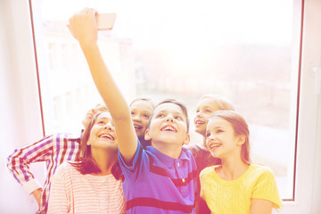 Canvas Print - group of school kids taking selfie with smartphone