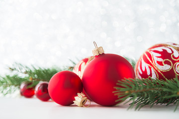 Wall Mural - red xmas ornaments on glitter holiday background. merry christmas card. winter theme. happy new year
