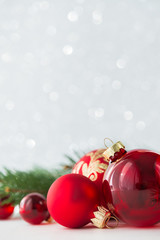 Wall Mural - red xmas ornaments on glitter holiday background. merry christmas card. winter theme. happy new year