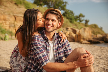 Wall Mural - Happy young couple having fun camping at the beach