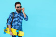 © kegfire - stylish hipster man in shirt over blue background with copyspace