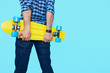 © kegfire - Hipster holding his skateboard with copy space