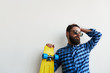 © kegfire - bearded hipster in checkered shirt holding yellow skateboard