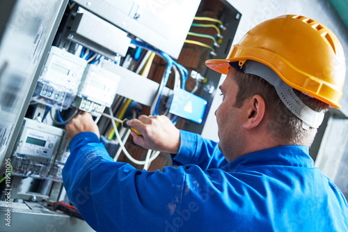 Fotografie, Obraz Electrician installing energy saving meter