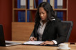© DragonImages - Asian business lady working with papers at her workplace