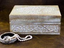 Old Carved Wood Jewellery Box And Pearl Necklace On Dark Background