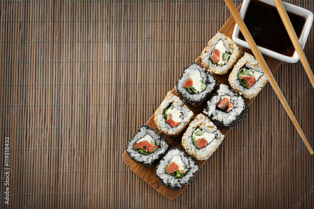 Delicious sushi rolls on table