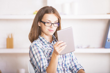 Wall Mural - Young woman using digital pad