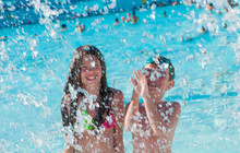 Two Kids Having Fun In Splashing Water