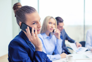 Sticker - smiling business team with smartphones in office