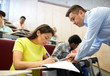 © Syda Productions - group of students and teacher with notebook