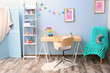 © Africa Studio - Wooden table in blue children room interior