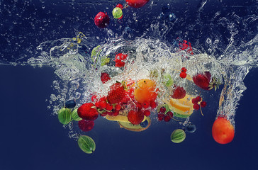 Wall Mural - Fruits falling into water on  color background