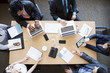 © Cavan Images - Overhead view of business people in meeting