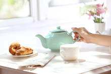 Woman Having Breakfast With Tea At Table
