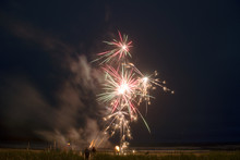 Low Angle View Of Fireworks At Beach Against Sky At Night