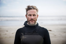 Portrait Of Confident Surfer Standing At Beach