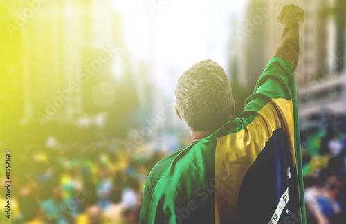 Fotografie, Obraz Adult holding the flag of Brazil in Paulista Avenue