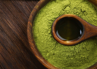 Wall Mural - Bowl with matcha tea on wooden background