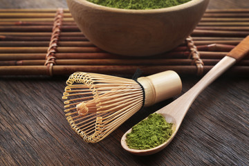 Wall Mural - Bamboo whisk and spoon with powdered matcha tea, closeup