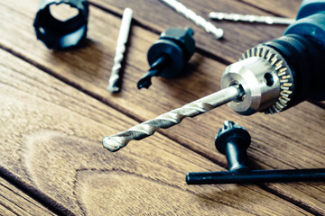 Wall Mural - power drill closeup on wooden background