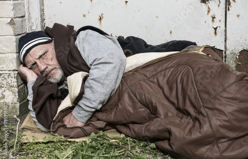 Homeless Man Laying In An Old Sleeping Bag On Cardboard Out On The Streets Stock Photo Adobe Stock Homeless Man Laying In An Old Sleeping Bag On Cardboard Out On The Streets Stock Photo Adobe Stock