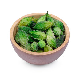 Momordica charantia fruits in wood bowl isolated on white backgr