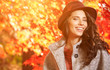 © ZoomTeam - Fashion woman on a background of red and yellow autumn leaves
