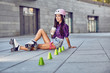 © belyjmishka - Beautiful young woman on roller skates and coffee cup. Happy teenager on rollerblading sitting on street and drink coffee at sunny day.