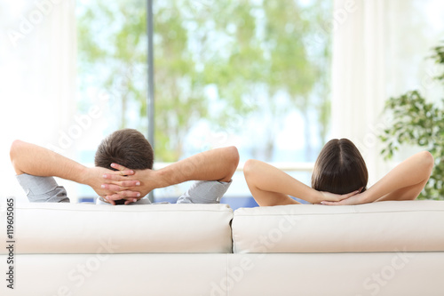 Couple relaxing on a couch at home Canvas Print