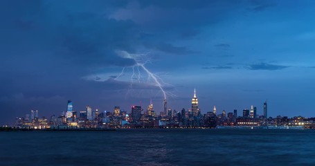 Fototapete - Cityscape time lapse of a summer evening storm and lightning in New York City. View of Manhattan Midtown West skyscrapers, West Village and Hudson River