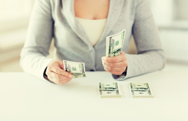 Poster - close up of woman hands counting us dollar money