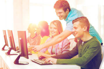 Wall Mural - smiling students in computer class at school