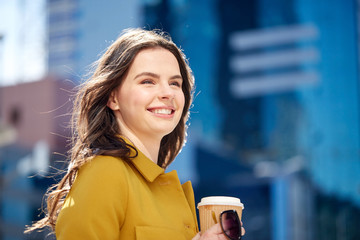 Poster - happy young woman drinking coffee on city street