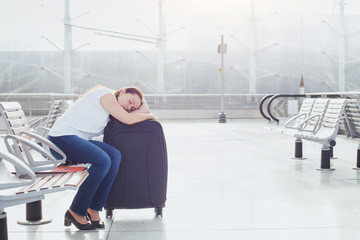 Wall Mural - woman sleeping in the airport, transit passenger