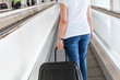 © Song_about_summer - passenger with suitcase luggage on travelator in airport