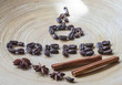 Coffee beans on a table made of bamboo, with cinnamon and star anise.