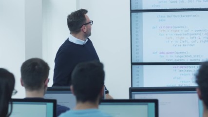 teacher speaking about programming on lecture in computer class. shot on red cinema camera in 4k (uh