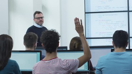 teacher speaking about programming on lecture in computer class. shot on red cinema camera in 4k (uh