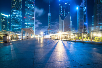 night view of empty brick floor front of modern building