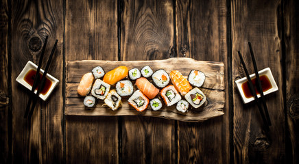 Sticker - Sushi and rolls seafood with soy sauce.