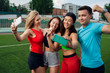 © SokRom - A group of happy young people smiling and doing selfie  on sports field. Looking great and we know it!