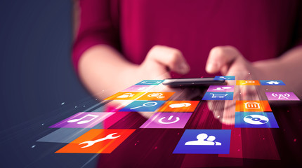 Woman holding smart phone with colorful application icons