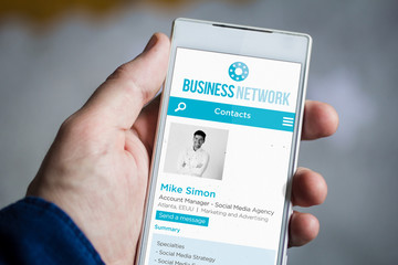 Canvas Print - holding business network smartphone