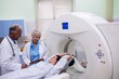 © Wavebreak Media - Doctors interacting with patient in scanning room