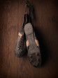 Old used sports shoes on a rustic wooden wall