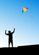 © ILYA AKINSHIN - man launches a kite in the sky, vector illustration